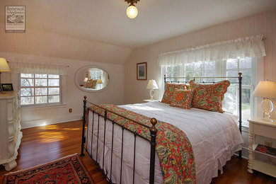 Bedroom - traditional medium tone wood floor bedroom idea in New York with beige walls
