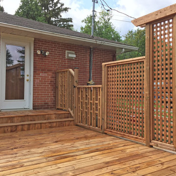Brown Treated Wood Deck with Custom Privacy Wall and Custom Bench