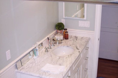 Bathroom photo in Orange County with white cabinets