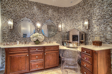 Example of a mid-sized classic master blue tile and glass tile marble floor corner bathtub design in Other with an undermount sink, raised-panel cabinets, medium tone wood cabinets, marble countertops, a two-piece toilet and beige walls