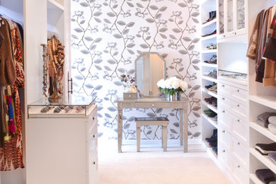 Inspiration for a transitional walk-in wardrobe in Los Angeles with white cabinets and carpet.