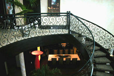 Huge tuscan carpeted curved open staircase photo in Other