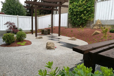 Photo of a small asian backyard garden in Other with natural stone pavers.