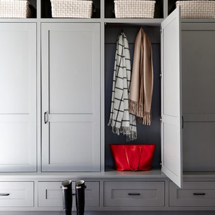 Mid-sized country mudroom in Philadelphia with white walls, brick floors and red floor.