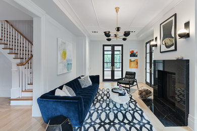 Living room - transitional open concept medium tone wood floor and brown floor living room idea in Ottawa with white walls and a standard fireplace