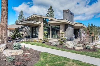 Inspiration for a contemporary beige two-story stucco exterior home remodel in Other