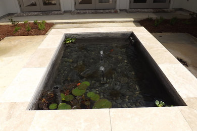 Small backyard concrete patio fountain photo in New Orleans with no cover