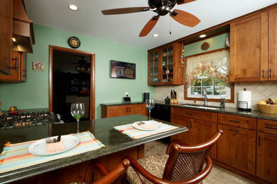 Example of a mid-sized mountain style eat-in kitchen design in Other with brown cabinets, granite countertops and green countertops