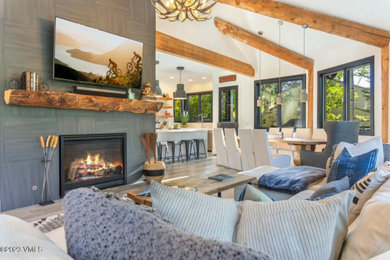 Living room - mid-sized modern open concept light wood floor, beige floor and vaulted ceiling living room idea in Other with white walls, no fireplace, a tile fireplace and a wall-mounted tv