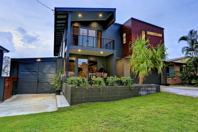 Inspiration for a large modern two-storey brick multi-coloured house exterior in Other with a metal roof.