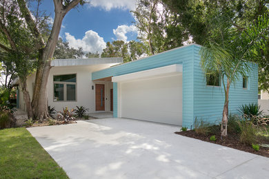 Mid-century modern attached garage photo in Tampa