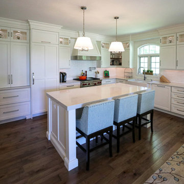 White Kitchen with Gray Quartz Countertops, Farmhouse Sink and Hardwood Floors