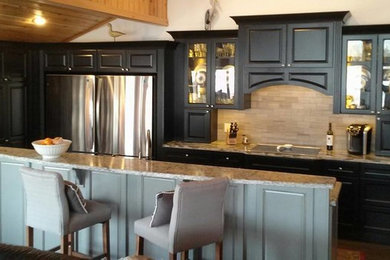 Example of a mid-sized transitional l-shaped medium tone wood floor eat-in kitchen design in Baltimore with an undermount sink, recessed-panel cabinets, dark wood cabinets, quartz countertops, beige backsplash, subway tile backsplash, stainless steel appliances and two islands