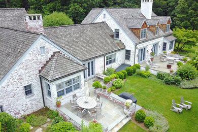 Mid-sized elegant white two-story brick house exterior photo in New York