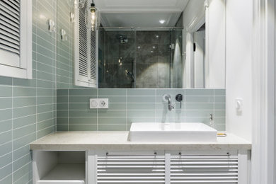 Photo of a mid-sized scandinavian bathroom in Saint Petersburg with louvered cabinets, white cabinets, an alcove shower, a wall-mount toilet, green tile, ceramic tile, green walls, ceramic floors, a drop-in sink, engineered quartz benchtops, green floor, black benchtops, a laundry, a single vanity and a floating vanity.