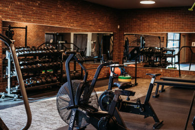 Example of a mid-sized urban multiuse home gym design in Austin with gray walls