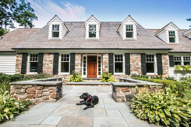 Example of a large arts and crafts white two-story mixed siding exterior home design in Philadelphia with a hip roof