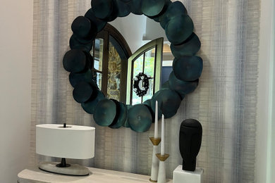 Modern entry hall niche- mirror,  accent lamp, candle sticks, sculpted head