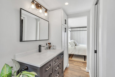 Example of a small eclectic brown floor and single-sink bathroom design in San Diego with white walls, an undermount sink, quartz countertops, white countertops and a floating vanity