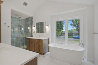 Example of a french country blue tile and glass tile white floor and vaulted ceiling freestanding bathtub design in Kansas City with brown cabinets, a drop-in sink, a hinged shower door and a built-in vanity