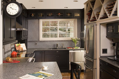 This is an example of a small traditional u-shaped eat-in kitchen in Seattle with an undermount sink, shaker cabinets, black cabinets, quartzite benchtops, multi-coloured splashback, mosaic tile splashback, stainless steel appliances, medium hardwood floors and a peninsula.