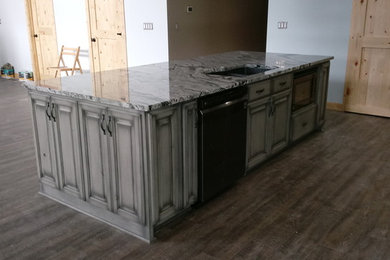 Example of a large mountain style vinyl floor and gray floor eat-in kitchen design in Indianapolis with an undermount sink, recessed-panel cabinets, gray cabinets, granite countertops, stainless steel appliances and an island