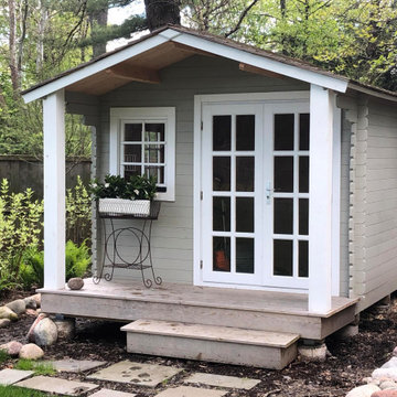 Cottage Storage Shed With Custom Pillars and Patio