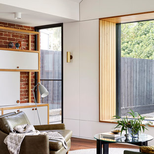 Immagine di un piccolo soggiorno contemporaneo aperto con pareti marroni, TV nascosta, pavimento marrone e pavimento in legno massello medio