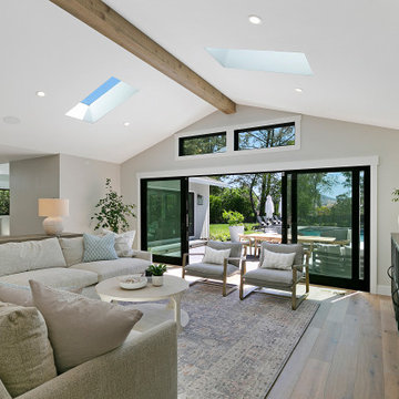 Transitional Living Room with Exposed Beam and Skylights