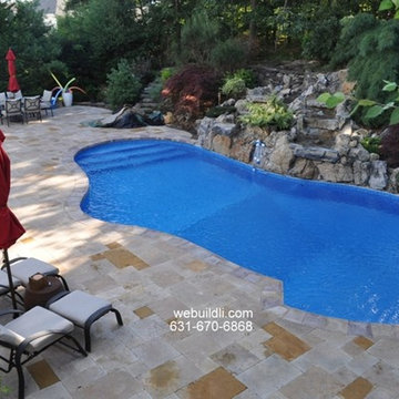 Travertine Pool Patio with a Natural Rock Waterfall