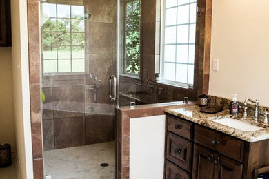 Example of a large minimalist master porcelain tile bathroom design in Austin with raised-panel cabinets, dark wood cabinets, beige walls, an undermount sink and granite countertops