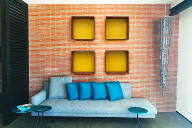 Example of a large urban loft-style concrete floor and gray floor family room design in Los Angeles with multicolored walls