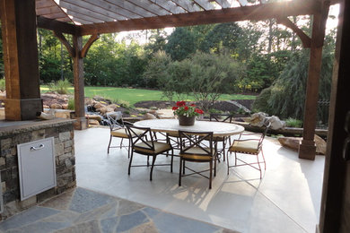 Large country backyard patio in Atlanta with an outdoor kitchen, concrete slab and a gazebo/cabana.