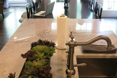 Inspiration for a large transitional single-wall dark wood floor and brown floor eat-in kitchen remodel in Detroit with an undermount sink, beaded inset cabinets, white cabinets, quartzite countertops, white backsplash, subway tile backsplash, stainless steel appliances and two islands