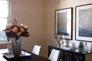 This is an example of a traditional dining room in Sydney with beige walls and dark hardwood floors.