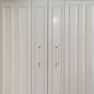 Elegant White Paneled Doors with Gold Accents
