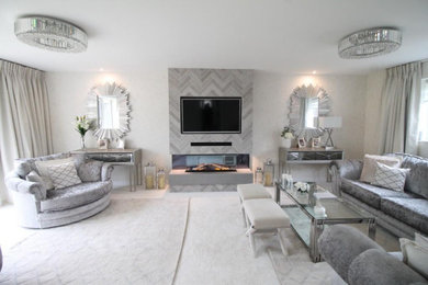 This is an example of a large contemporary living room in Other with beige walls, a tiled fireplace surround, a wall mounted tv, white floors and wallpapered walls.