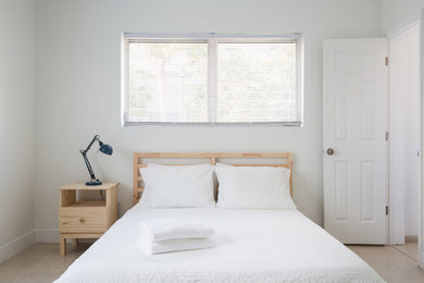 Photo of a large contemporary master bedroom in Other with white walls and ceramic floors.