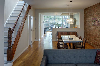 Minimalist medium tone wood floor kitchen/dining room combo photo in New York with no fireplace