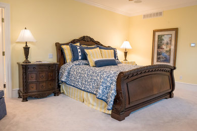 Inspiration for a timeless master carpeted and beige floor bedroom remodel in Other with yellow walls