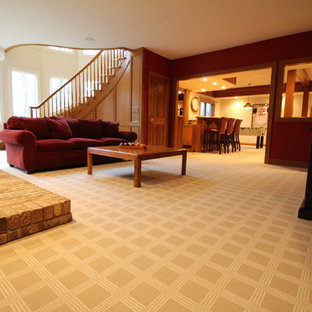 Large classic walk-out basement in Columbus with red walls, carpet, a standard fireplace and a brick fireplace surround.