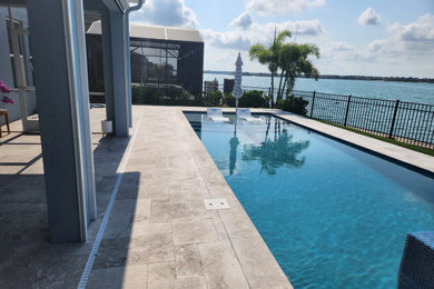 Mid-sized backyard stone and rectangular lap pool landscaping photo in Orlando