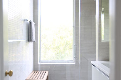 Bathroom - mid-sized modern kids' bathroom idea in New York with flat-panel cabinets, white cabinets and solid surface countertops