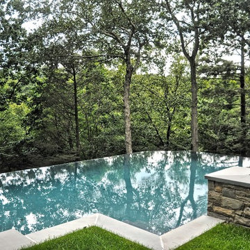 cliffside vanishing edge pool with raised spa + surge current