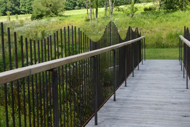 Photo of a huge rustic full sun landscaping in New York with decking for summer.