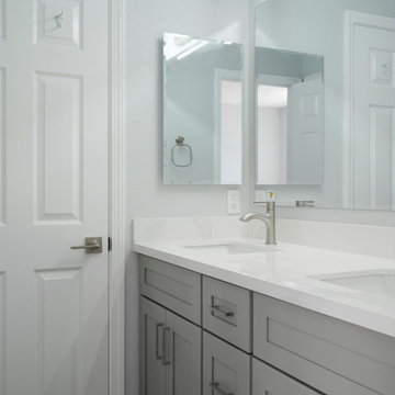 This modern kitchen remodel blends crisp white upper cabinetry with warm natural