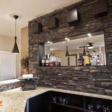 Pioneering Exquisite DesignStone basement wetbar and dark wood cabinetry
