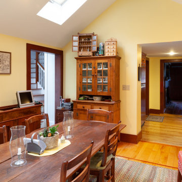 Warm Yellow Dining Room with Skylight and Antique Wood Furniture – South Hamilto