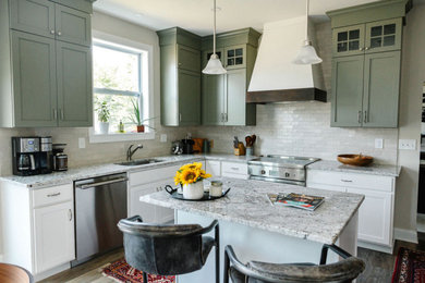 Mid-sized transitional l-shaped medium tone wood floor and gray floor open concept kitchen photo in Other with an undermount sink, shaker cabinets, green cabinets, granite countertops, beige backsplash, ceramic backsplash, stainless steel appliances, an island and white countertops