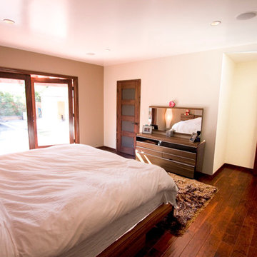 Primary Bedroom With Mirrored Dresser and French Doors